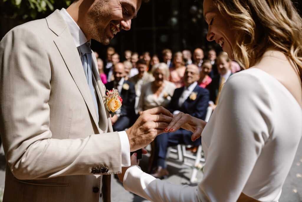Bruidspaar omringd door gasten tijdens hun trouwceremonie in Utrecht stad.