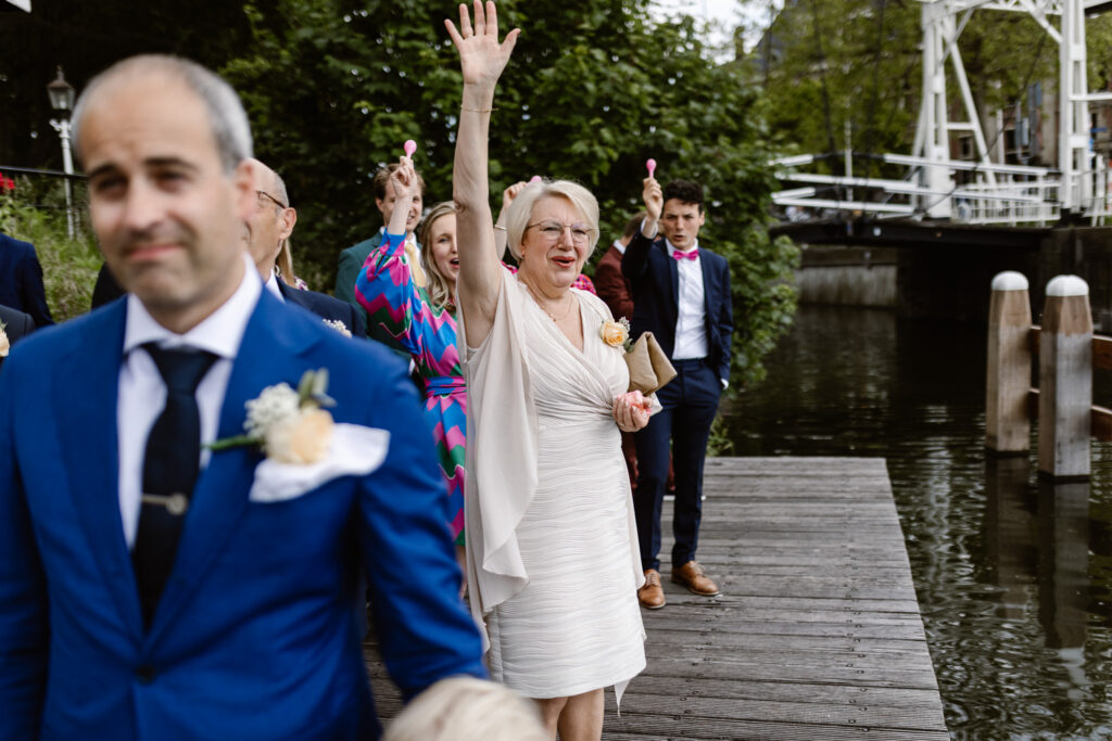 Gasten wachten enthousiast aan de waterkant bij het Muntgebouw Utrecht.
